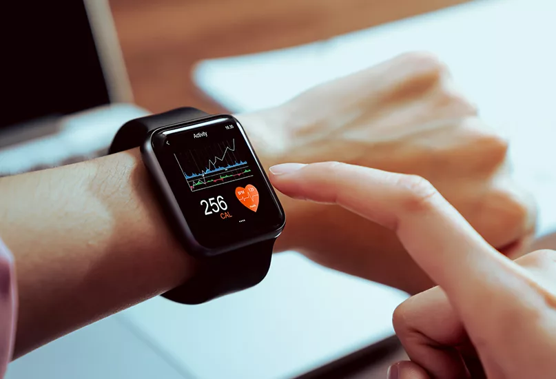 Close up of hand touching smartwatch with health app