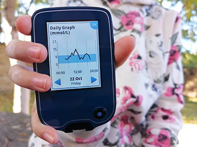 Girl with diabetes reading glucose levels