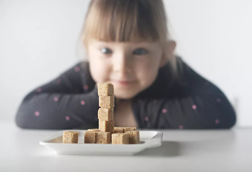 Child with sugar cubes.