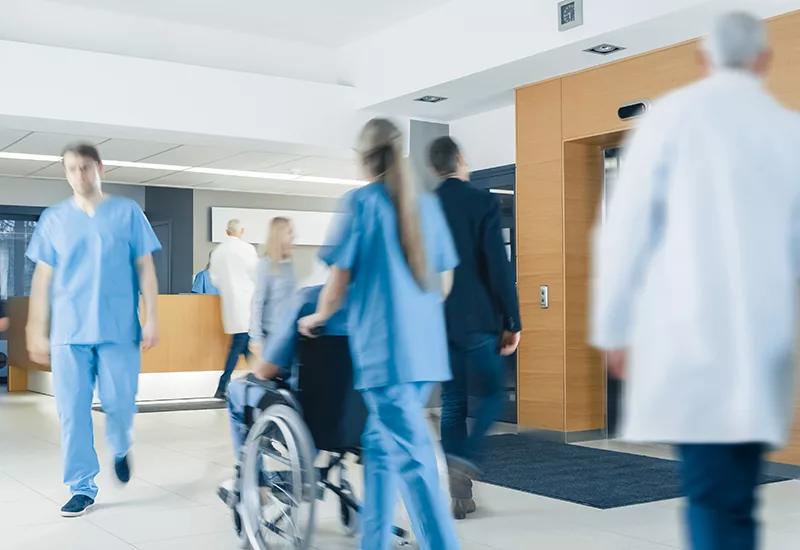 Hospital Lobby. Doctors, Nurses, Assistant Personnel and Patient