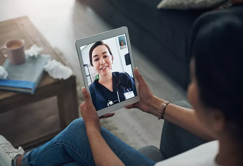 Shot of person on a videocall with a doctor.